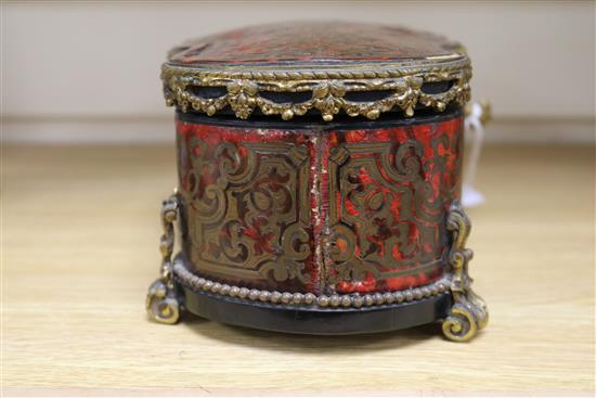 A boulle gilt metal mounted shaped rectangular casket, with lifting top and two doors, inlaid with brass scroll work, length 29cm